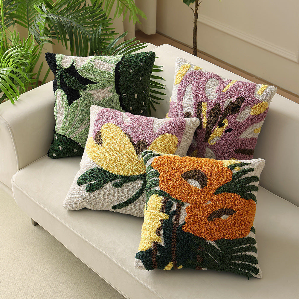 Hand-tufted decorative cushion with abstract graphic design and textured cotton surface