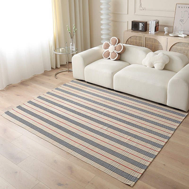 Woven living area rug with large check pattern and flat cotton texture