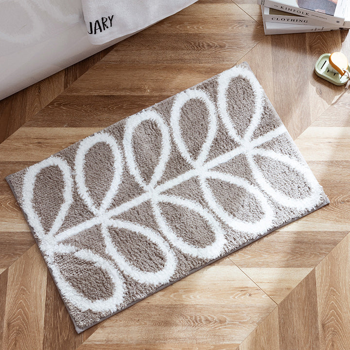 Fluffy bath mat in a graphic wave relief with anti-slip base