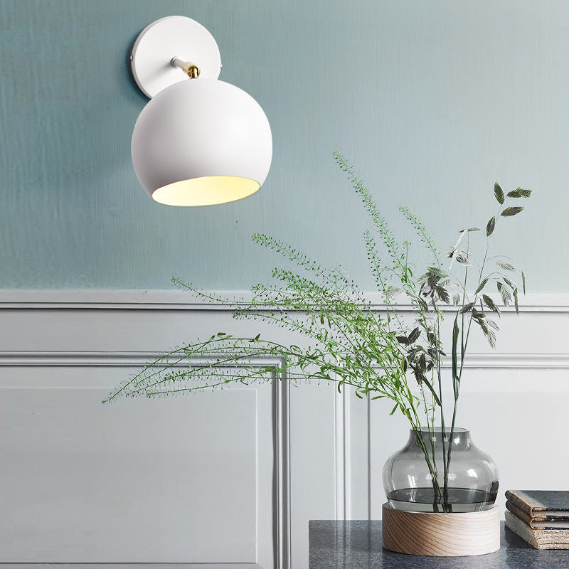 Adjustable matte metal globe wall lamp with brass pivot arm