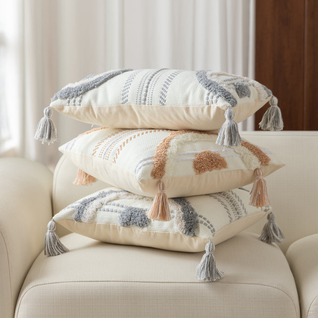 Woven decorative cushion cover with semi-circular tuft appliqué, fringe tassels, and concealed zipper