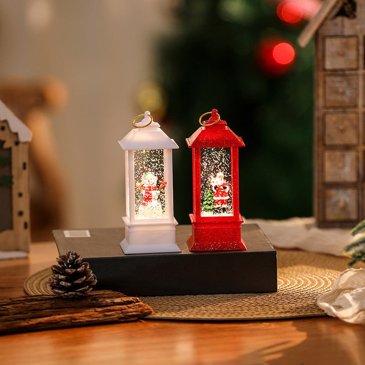 Illuminated Christmas lantern with glittering snowman scene