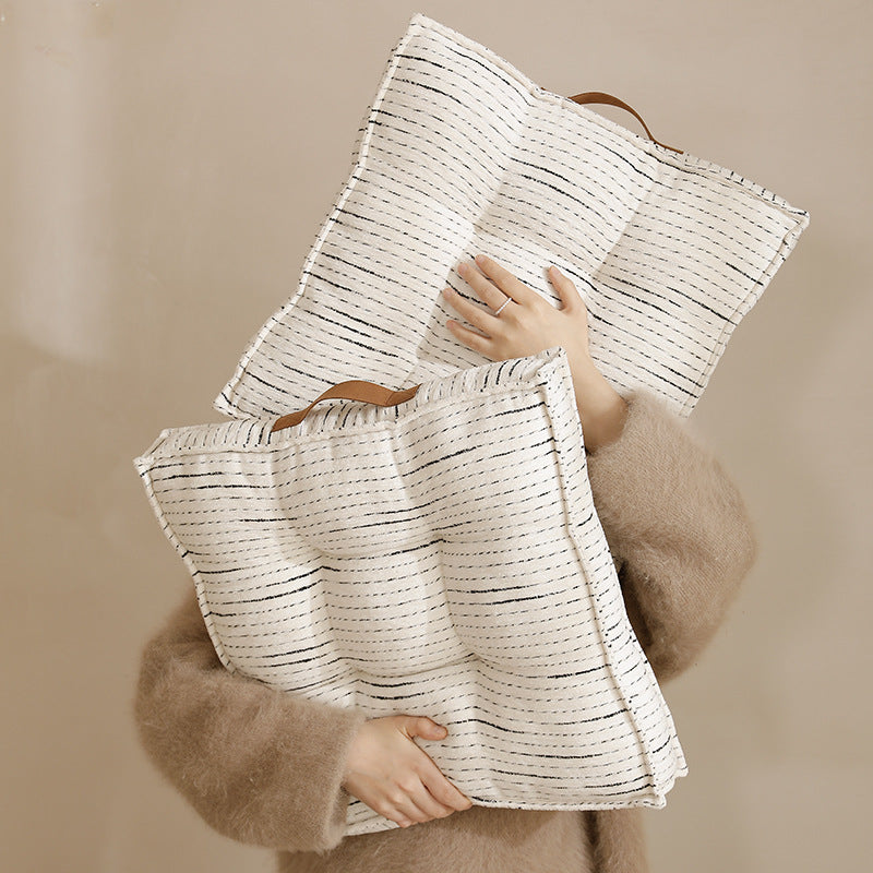 Padded square seat and floor cushion with quilted tufted padding and carrying handle