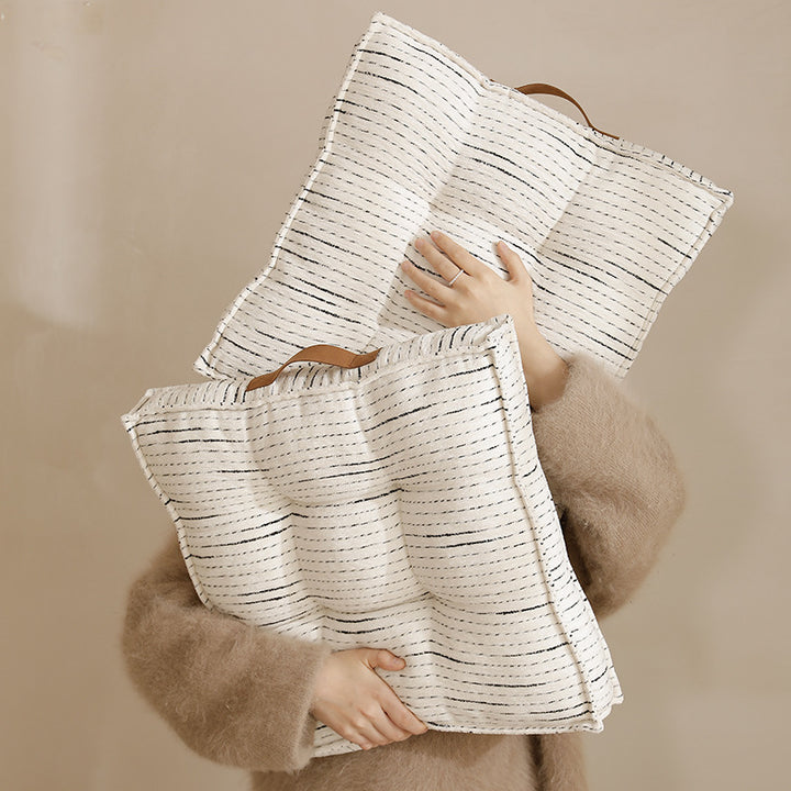 Padded square seat and floor cushion with quilted tufted padding and carrying handle