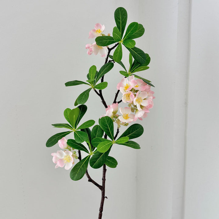 Artificial flower branch with fine pink flowers and vibrant leaves