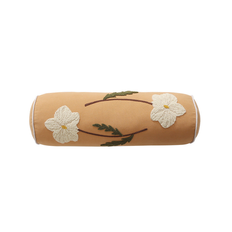 Bolster pillow with hand-stitched floral motif and decorative piping