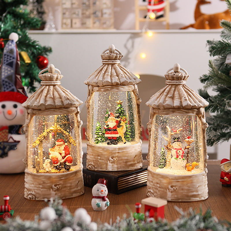 Illuminated Christmas lantern with snow scenes