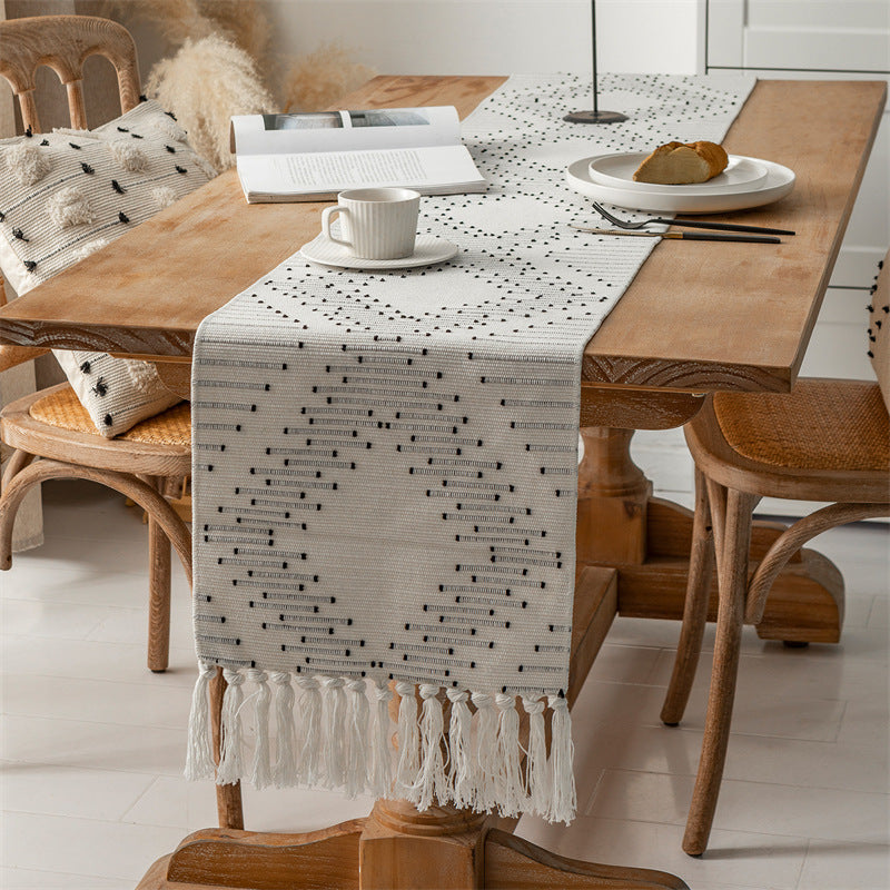 Handwoven table runner made of cotton blend with fringes and geometric dot jacquard