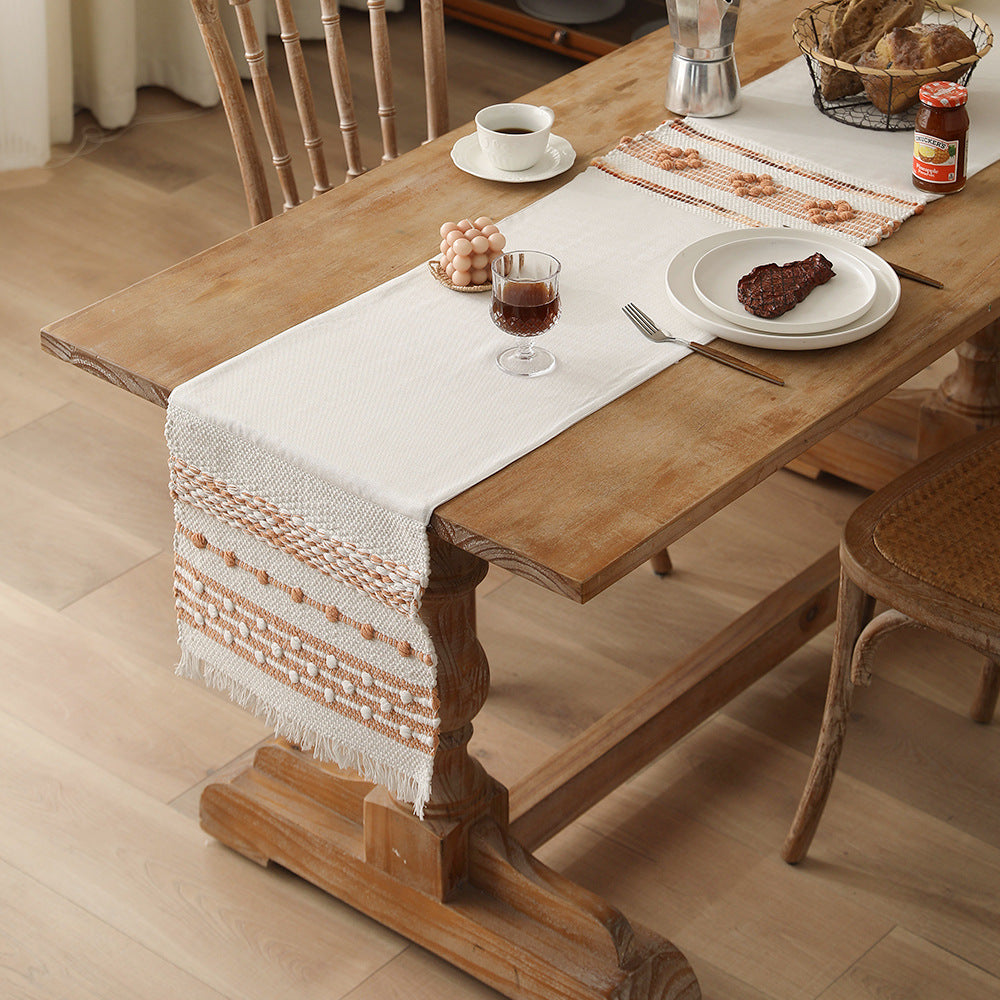 Woven cotton table runner with fringes and textured pattern