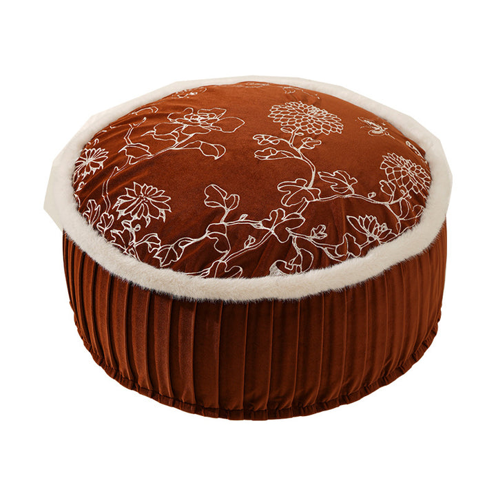 Round velvet floor pouf with floral embroidered top and faux fur trim