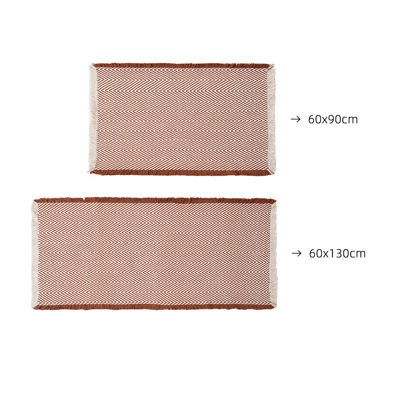 Handwoven cotton bath mat with herringbone pattern and fringes