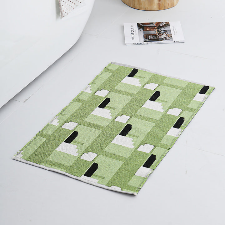 Modern geometric bathroom rug made of flat-woven cotton with non-slip backing
