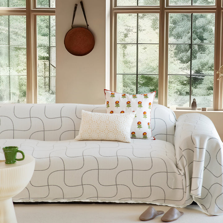 Woven sofa cover with geometric pattern, elastic corners and anti-slip
