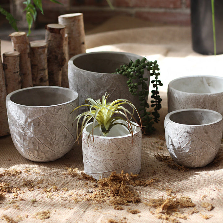 Decorative plant container made of handmade ceramic with leaf pattern