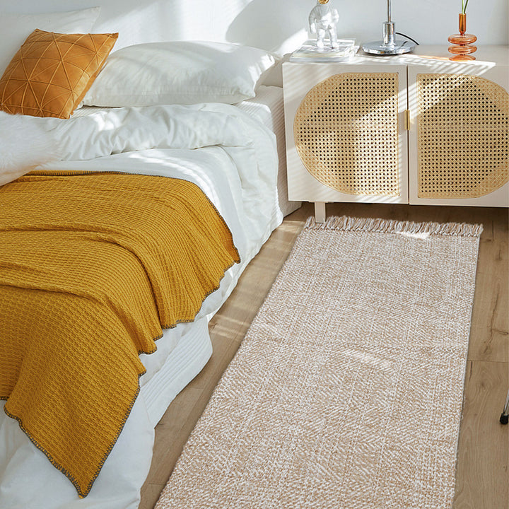 Woven table runner made of cotton blend with fine structure and herringbone look as well as decorative fringes