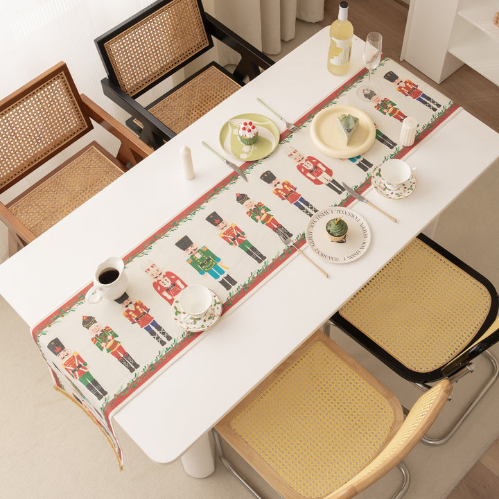 Festive woven table runner with nutcracker motif and golden fringes