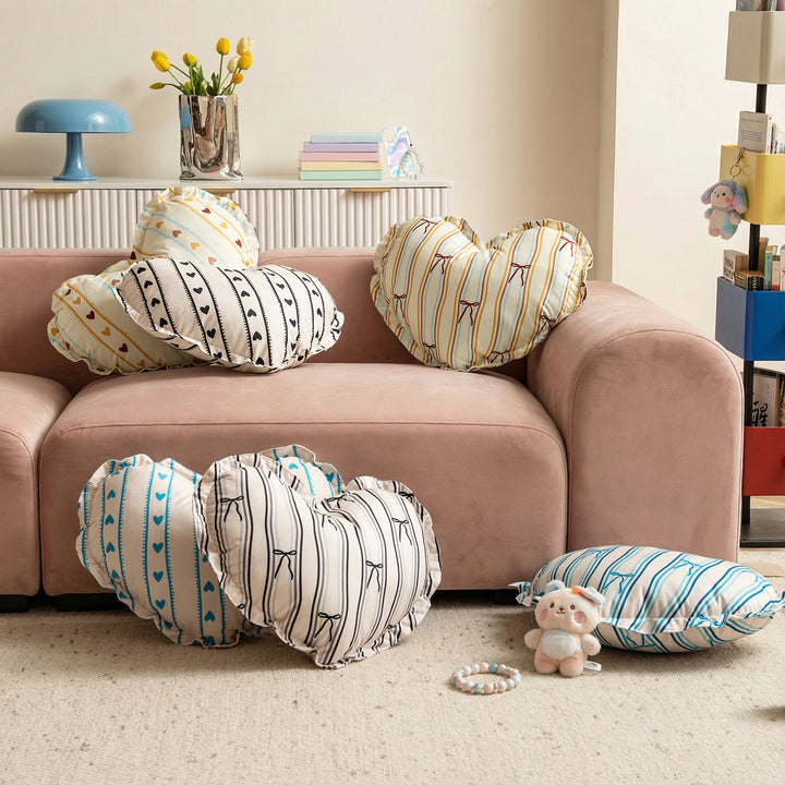 Heart-shaped decorative pillow with ruffled edge and heart pattern