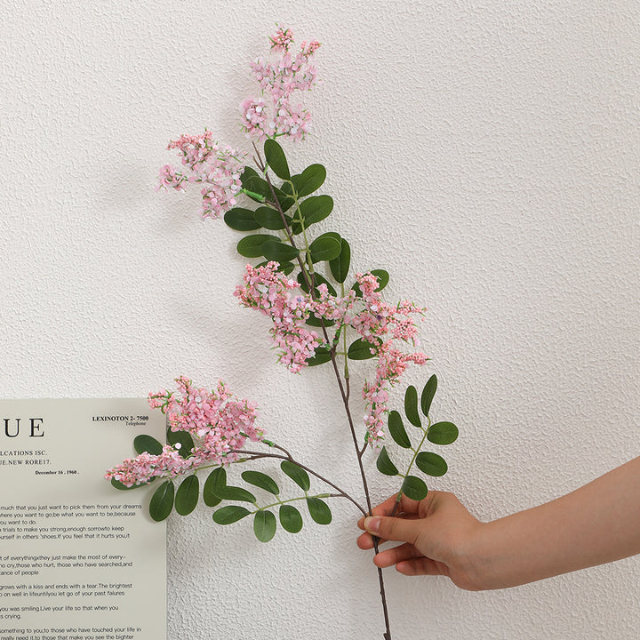 Artificial flower branch with vibrant purple flowers