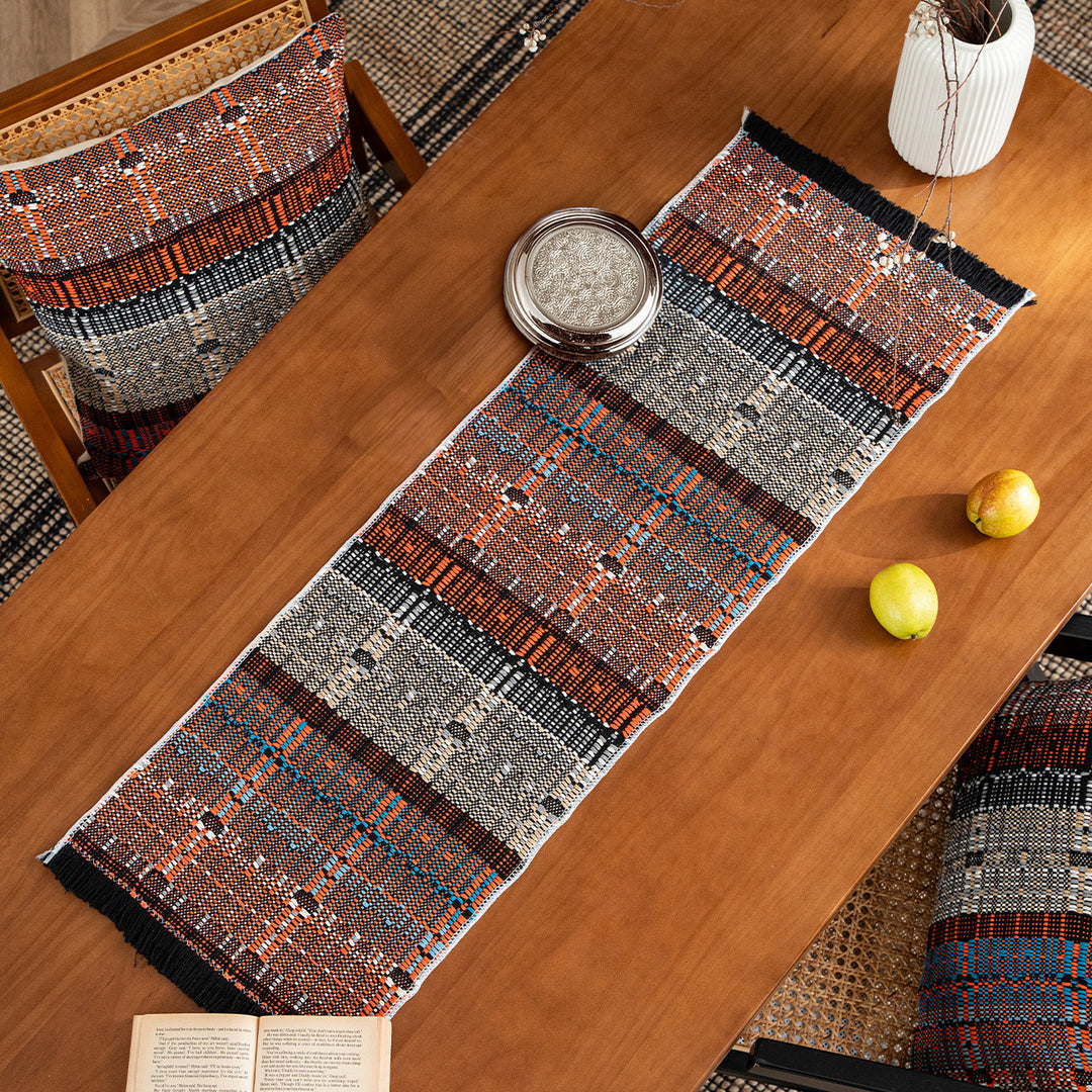 Woven table runner in ethnic look made of cotton blend with fringes