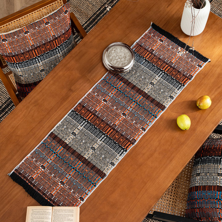 Woven table runner in ethnic look made of cotton blend with fringes