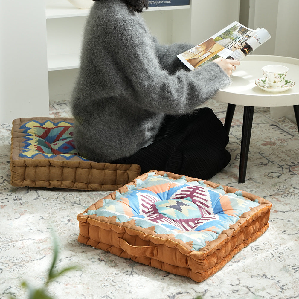 Padded seat and floor cushion with carrying handle and graphic ethno pattern