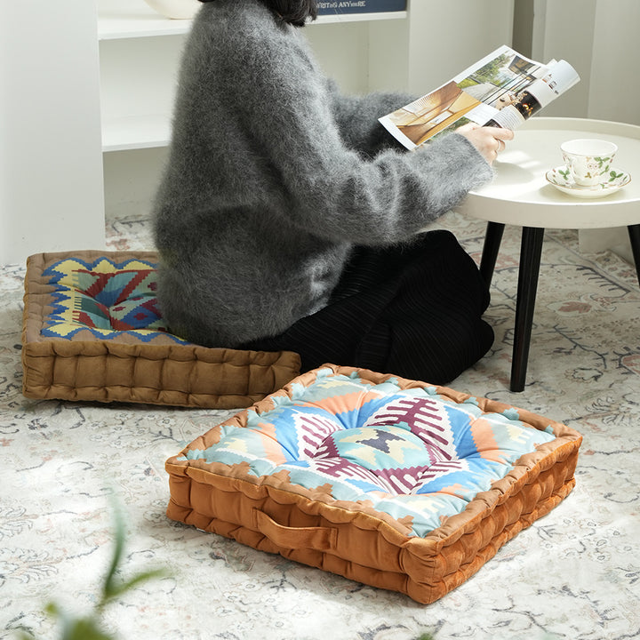 Padded seat and floor cushion with carrying handle and graphic ethno pattern