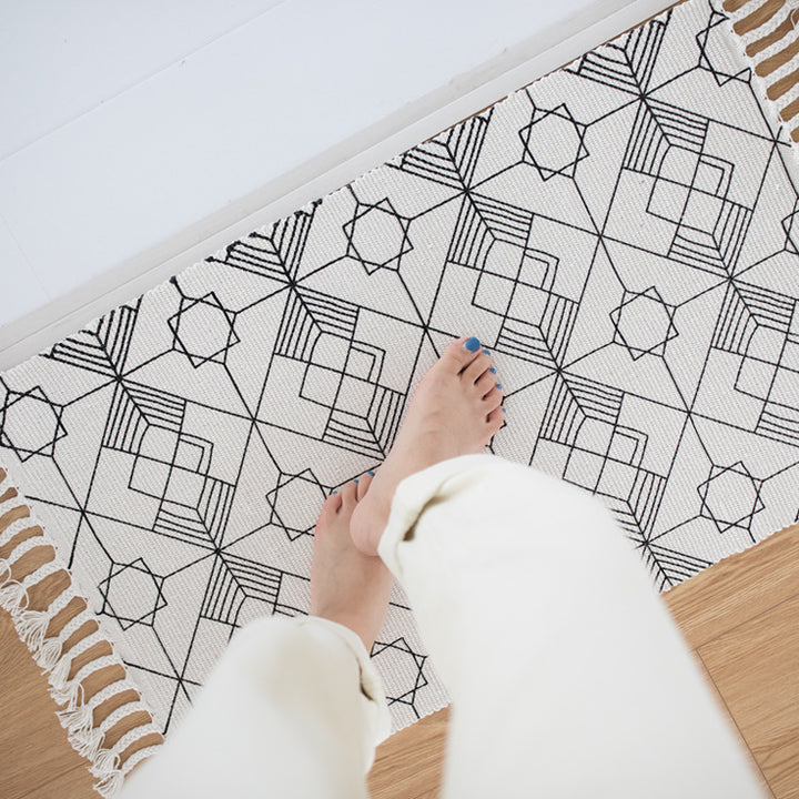 Flat-woven cotton table runner in Art Deco geometry jacquard with hand-fringed edge