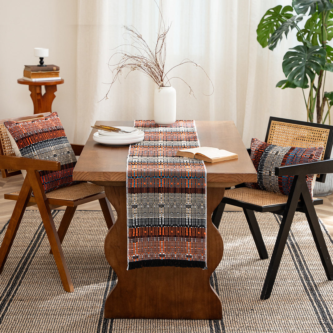 Woven table runner in ethnic look made of cotton blend with fringes