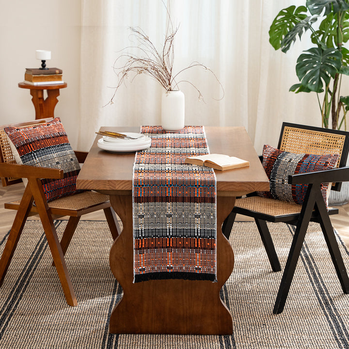 Woven table runner in ethnic look made of cotton blend with fringes