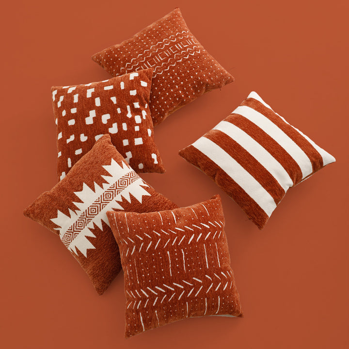Woven cushion cover with graphic ethnic pattern and contrasting borders