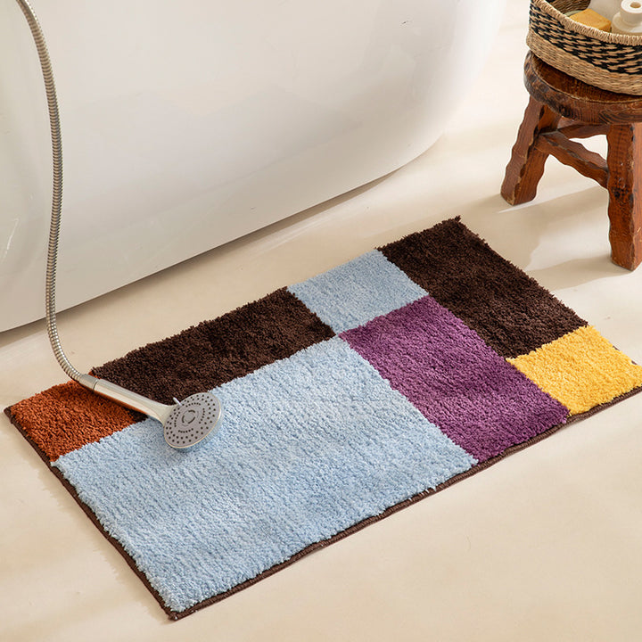 High-pile bath mat with geometric color block design and non-slip underside