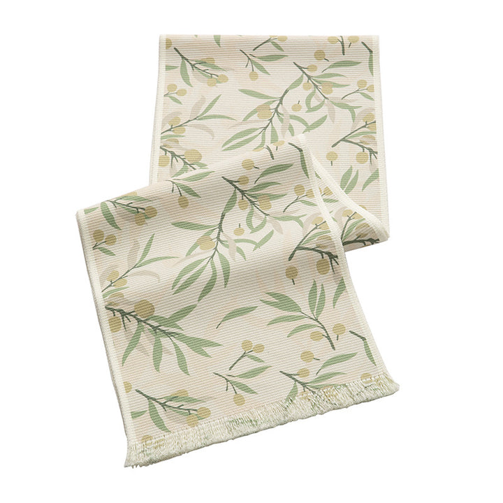 Woven table runner with floral jacquard pattern and fringed edge
