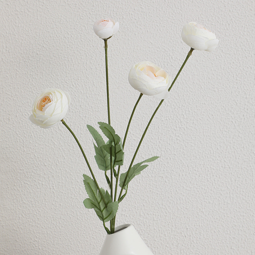 Decorative artificial flower bouquet with intricately detailed ranunculus