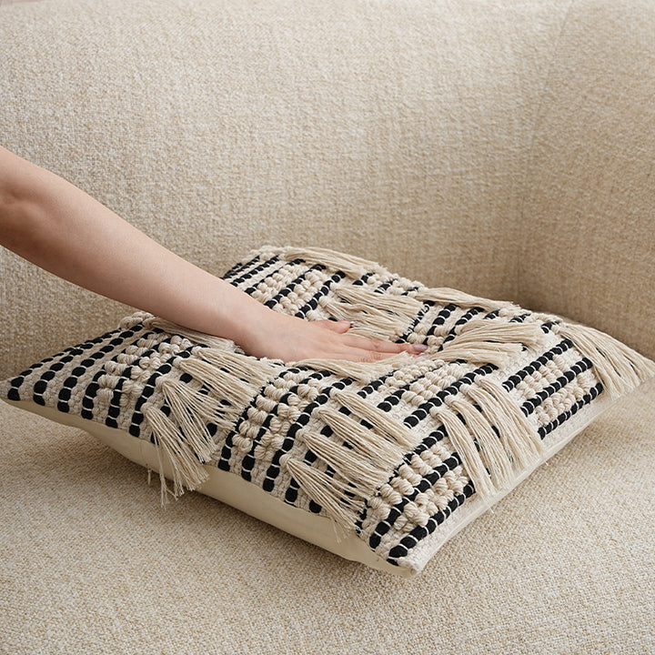 Square woven decorative pillow cover with tiered tassels and textured cotton surface