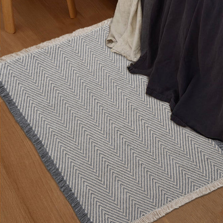 Handwoven cotton bath mat with herringbone pattern and fringes
