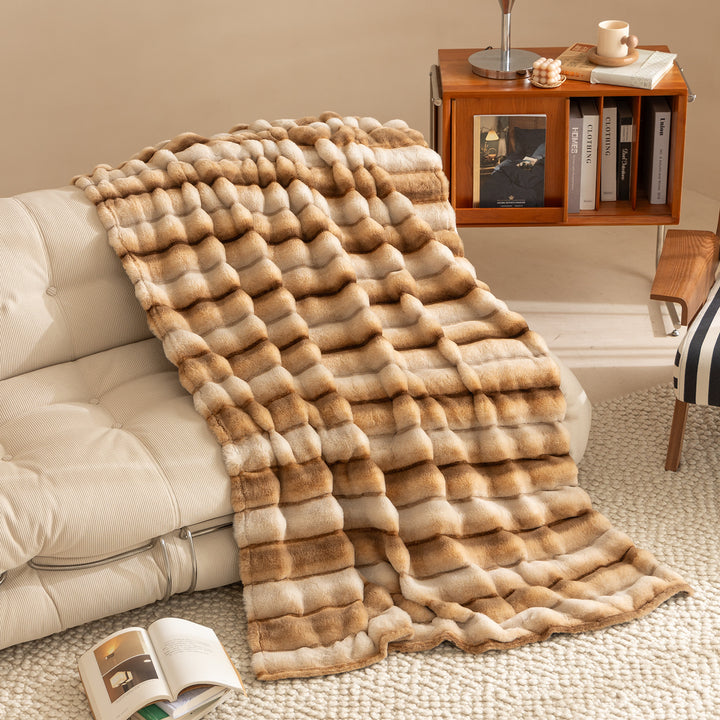 Luxurious faux fur throw blanket with relief-style quilting