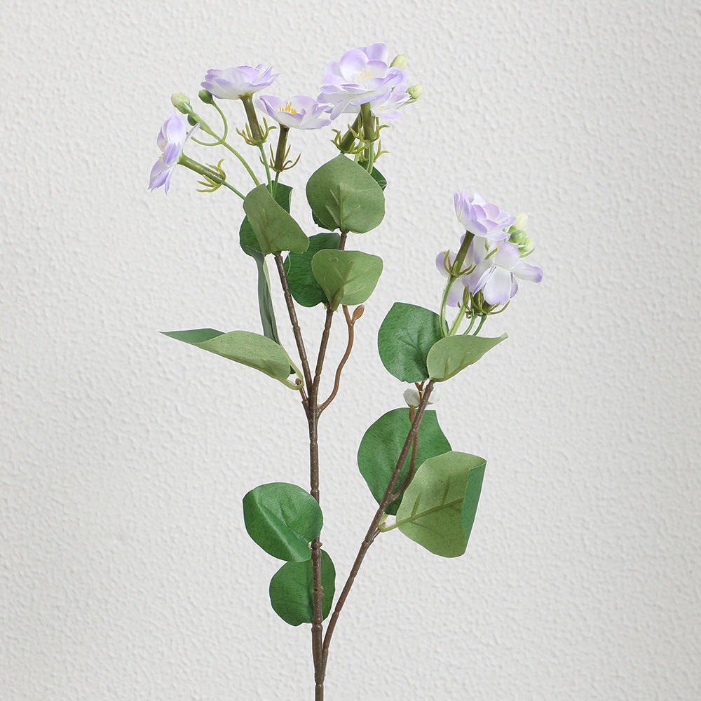 Artificial flower branch with vibrant pink flowers