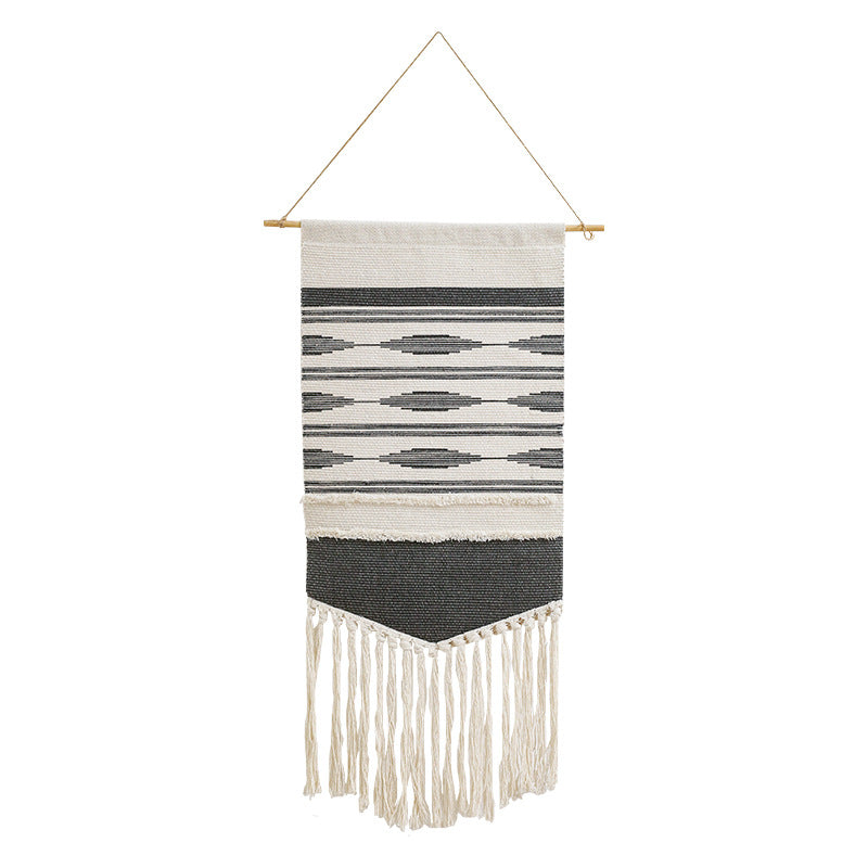 Handwoven wall hanging made of cotton blend with layered textures, wood rod and long fringes