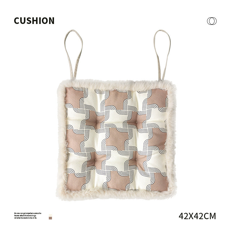 Padded seat cushion with fastening straps, quilted tufting surface and faux fur trim