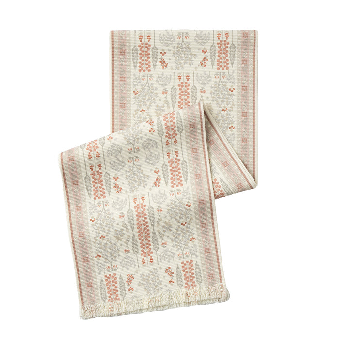 Vintage-inspired woven table runner with floral border and fringes