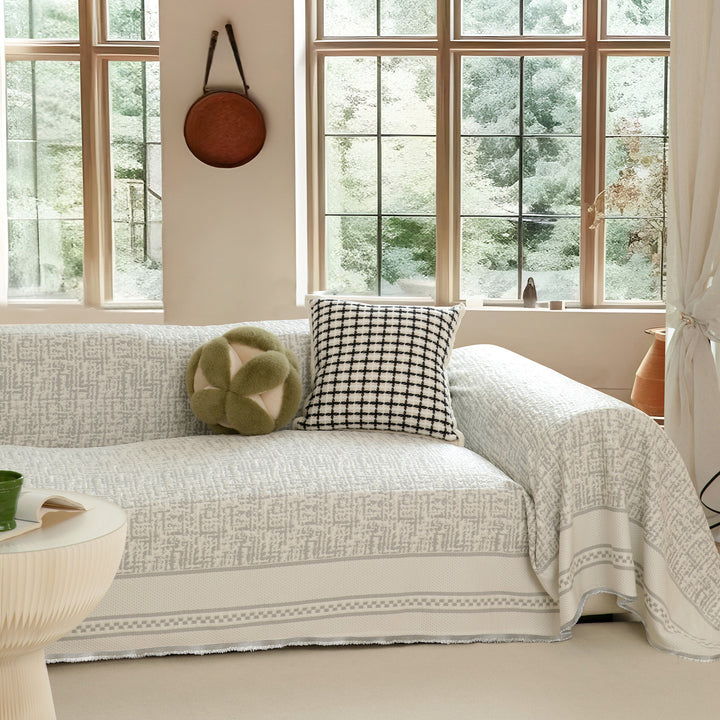 Woven sofa cover with geometric pattern, elastic corners and anti-slip