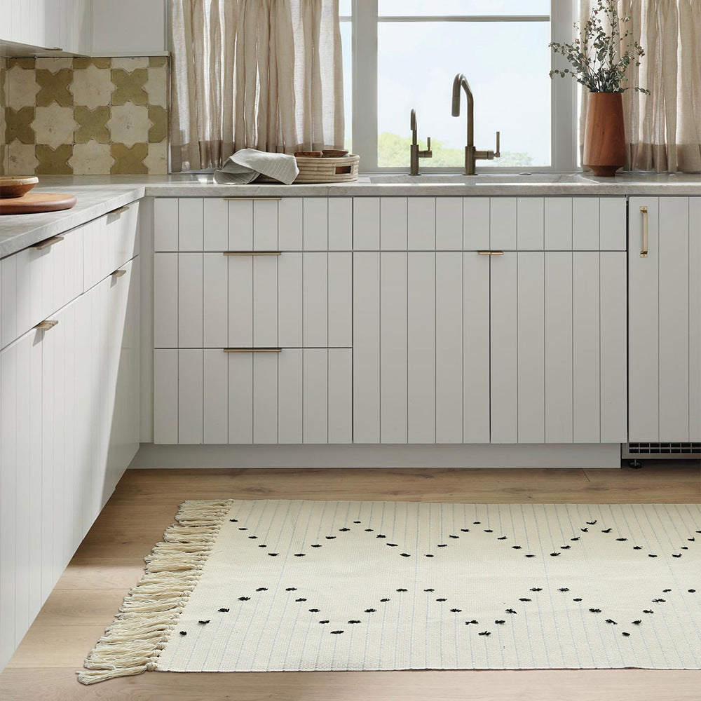handwoven living room rug with fringes and geometric perforated pattern