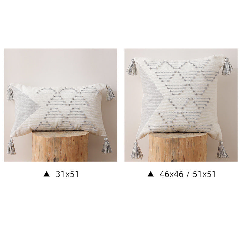 Decorative woven cushion cover with geometric tuft-relief and tassels