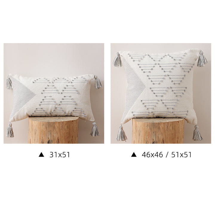 Decorative woven cushion cover with geometric tuft-relief and tassels