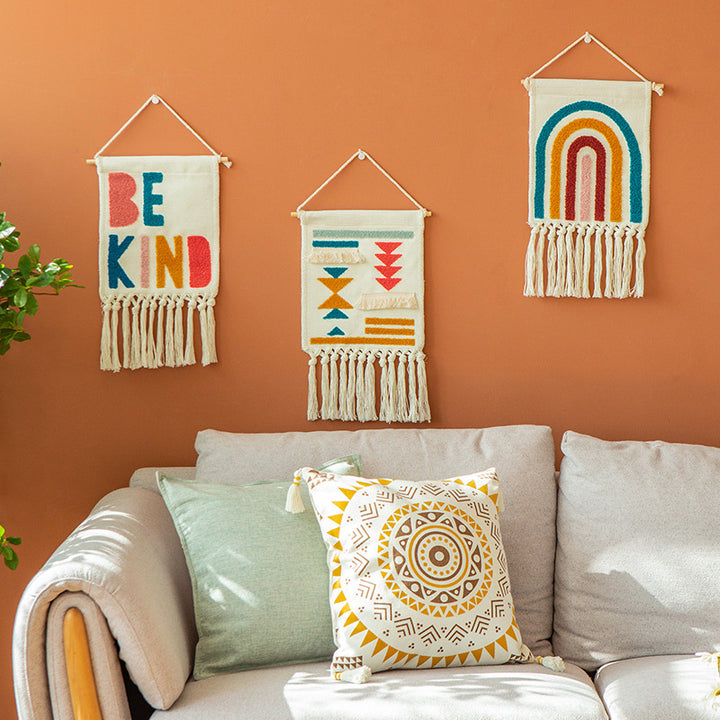Boho wall hanging made of woven cotton with hand-tufted appliqués and fringes