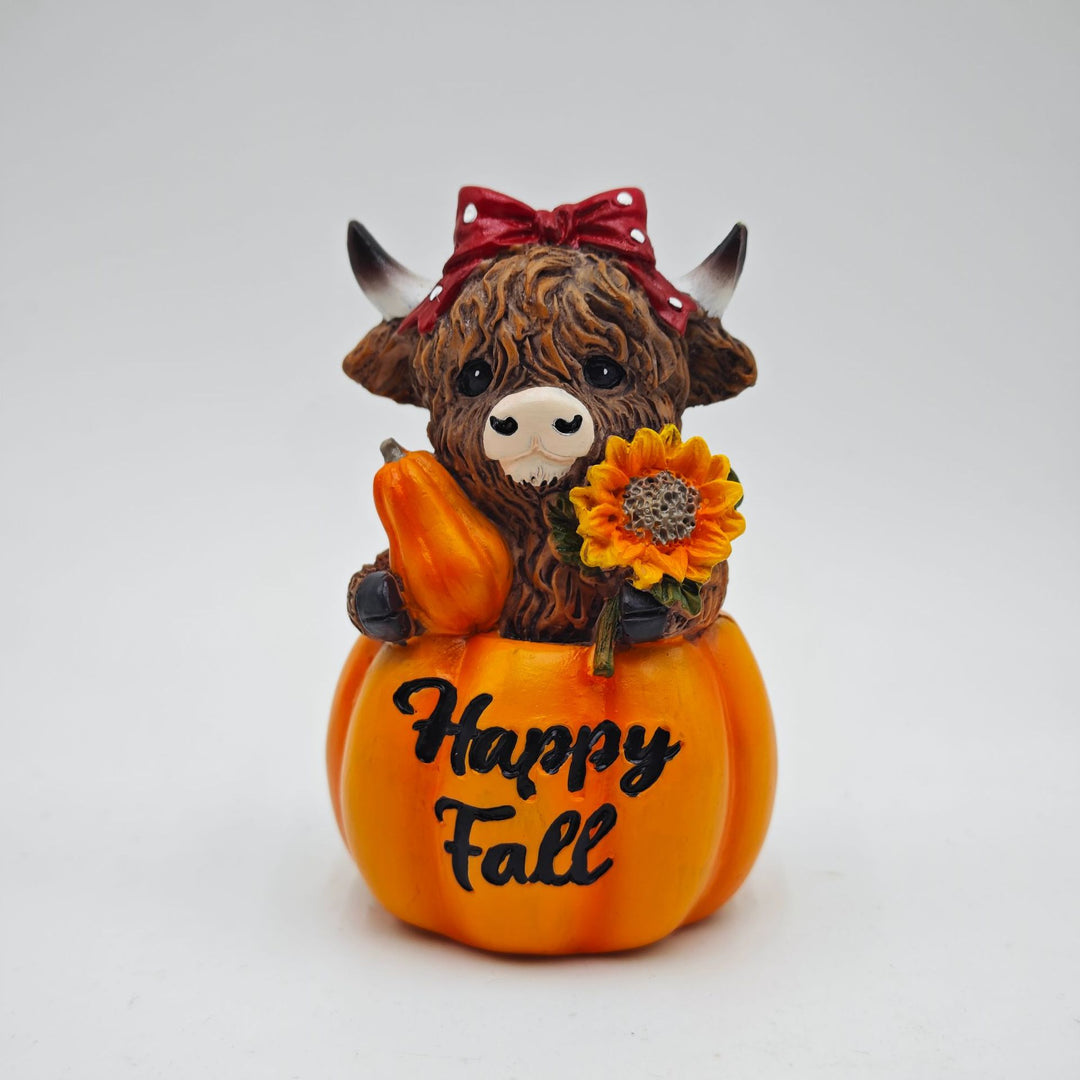 Funny decorative figure of a Highland cow in pumpkin costume