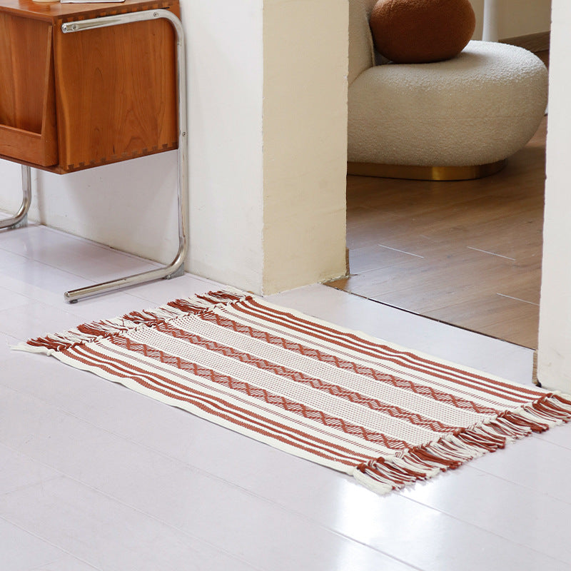 Flat-woven cotton runner with fringes and graphic ethnic stripe pattern