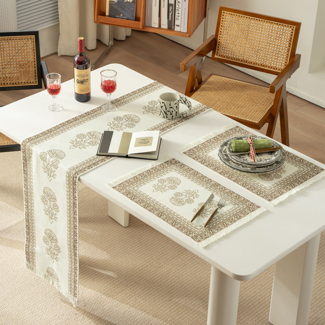 Round handmade woven decorative rug with fringes and botanical pattern