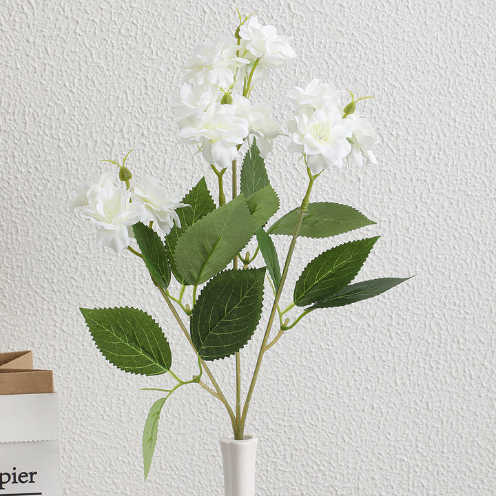 Artificial flower arrangement with delicate white blooms