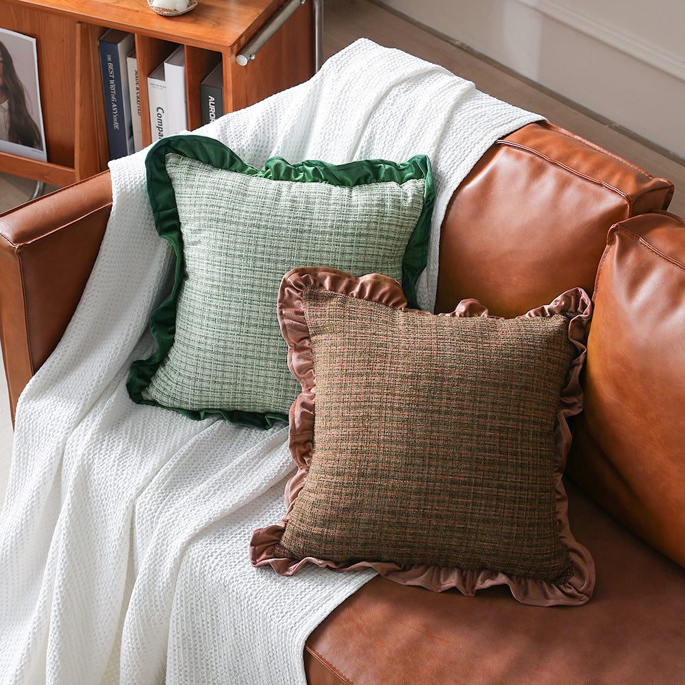 Decorative cushion with woven bouclé structure and velvet ruffled edge
